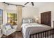 Sunlit bedroom featuring a comfortable chair and large window with desert views at 7547 E Mary Sharon Dr, Scottsdale, AZ 85266