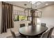 Elegant dining room featuring a dark wood table, comfortable seating, and designer lighting fixtures at 7547 E Mary Sharon Dr, Scottsdale, AZ 85266