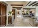 Charming foyer with a decorative wooden door and beamed ceilings leading into an open living and kitchen area at 7547 E Mary Sharon Dr, Scottsdale, AZ 85266