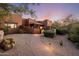 Desert home featuring an inviting walkway leading to a covered porch and beautiful desert landscaping at 7547 E Mary Sharon Dr, Scottsdale, AZ 85266