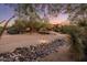 Inviting desert home featuring professional landscaping, mature trees, and warm exterior paint at 7547 E Mary Sharon Dr, Scottsdale, AZ 85266