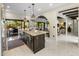 Spacious kitchen with a center island, stainless steel appliances, and access to the outdoor dining area at 7547 E Mary Sharon Dr, Scottsdale, AZ 85266