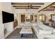Stylish living room featuring beamed ceilings, a fireplace, and large windows filling the space with natural light at 7547 E Mary Sharon Dr, Scottsdale, AZ 85266