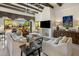 Comfortable living room with beamed ceilings, a cozy fireplace, and large windows offering great views of the patio at 7547 E Mary Sharon Dr, Scottsdale, AZ 85266