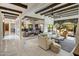 Spacious living room showcasing beamed ceilings, stylish furnishings, and an open layout connecting to the kitchen at 7547 E Mary Sharon Dr, Scottsdale, AZ 85266