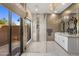 Stunning bathroom featuring double vanities, a glass-enclosed shower, and outdoor access at 7547 E Mary Sharon Dr, Scottsdale, AZ 85266
