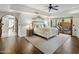 Serene main bedroom with wood floors, decorative headboard, and sliding glass doors leading to an outdoor space at 7547 E Mary Sharon Dr, Scottsdale, AZ 85266