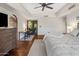 Large bedroom featuring hardwood floors, a ceiling fan, and a dedicated workspace at 7547 E Mary Sharon Dr, Scottsdale, AZ 85266