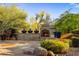Stone outdoor fireplace and landscaped area offering a cozy and inviting space for relaxation and entertaining guests at 7547 E Mary Sharon Dr, Scottsdale, AZ 85266