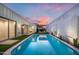 A backyard oasis featuring a sparkling pool, privacy walls, and artificial turf at 7646 E Catalina Dr, Scottsdale, AZ 85251