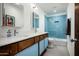 Modern bathroom featuring double sinks, a blue tiled shower, and sleek fixtures at 7646 E Catalina Dr, Scottsdale, AZ 85251