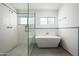 Modern bathroom featuring a freestanding tub, a glass-enclosed shower, and clean design at 7646 E Catalina Dr, Scottsdale, AZ 85251