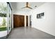 Bright bedroom with sliding glass doors, a wood ceiling fan, and closet doors at 7646 E Catalina Dr, Scottsdale, AZ 85251