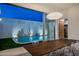 Contemporary dining room with sleek table, chairs, and views of the backyard pool at 7646 E Catalina Dr, Scottsdale, AZ 85251