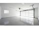 Clean, bright garage with a large glass door and a pristine epoxy floor at 7646 E Catalina Dr, Scottsdale, AZ 85251