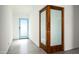 Bright hallway featuring a light blue door, a sliding wood door, and modern gray flooring at 7646 E Catalina Dr, Scottsdale, AZ 85251