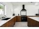 Well-lit kitchen featuring wood cabinets, white countertops, and modern appliances at 7646 E Catalina Dr, Scottsdale, AZ 85251