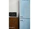 A SMEG fridge and vintage microwave oven sit atop wood kitchen drawers at 7646 E Catalina Dr, Scottsdale, AZ 85251
