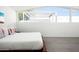 A spacious main bedroom with bright light, modern furniture, and decorative pillows at 7646 E Catalina Dr, Scottsdale, AZ 85251