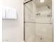 Bright bathroom featuring a glass shower with white tiled walls and chrome fixtures at 7684 E Minnezona Ave, Scottsdale, AZ 85251