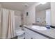 Bathroom with a shower and tub combo, single sink, and neutral walls at 7684 E Minnezona Ave, Scottsdale, AZ 85251