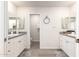 Bright bathroom featuring double vanity sinks with mirrors at 7684 E Minnezona Ave, Scottsdale, AZ 85251