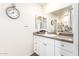 Bathroom featuring vanity sink, mirror and clock at 7684 E Minnezona Ave, Scottsdale, AZ 85251