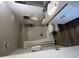 A clean bathroom features a shower-tub combo with curtain, toilet, vanity with sink, and decorative mirror at 7684 E Minnezona Ave, Scottsdale, AZ 85251