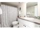 Bathroom features a grey and white vanity, a shower with a patterned curtain at 7684 E Minnezona Ave, Scottsdale, AZ 85251
