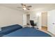 Bedroom with two twin beds, ceiling fan, desk, and ensuite bath at 7684 E Minnezona Ave, Scottsdale, AZ 85251