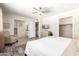 Spacious bedroom with chair, ceiling fan and light neutral decor at 7684 E Minnezona Ave, Scottsdale, AZ 85251