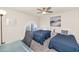 Cozy bedroom featuring carpet, two beds, a ceiling fan, and a window with shutters at 7684 E Minnezona Ave, Scottsdale, AZ 85251