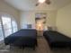 Comfortable bedroom features two twin beds, ceiling fan, and a window with attractive shutter coverings at 7684 E Minnezona Ave, Scottsdale, AZ 85251