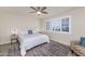 Bedroom with a queen bed, side tables, plantation shutters, and neutral walls at 7684 E Minnezona Ave, Scottsdale, AZ 85251