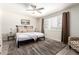 Inviting bedroom with a ceiling fan, plush rug, and comfortable bed with neutral tones at 7684 E Minnezona Ave, Scottsdale, AZ 85251