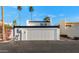 Exterior of home with a two-car garage, two palm trees, and bougainvillea at 7684 E Minnezona Ave, Scottsdale, AZ 85251
