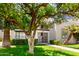 Beautiful two-story condo with manicured lawn, mature trees, and secure gated entry at 7684 E Minnezona Ave, Scottsdale, AZ 85251