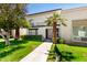Charming two-story condo featuring a gated entry, balcony, and mature landscaping at 7684 E Minnezona Ave, Scottsdale, AZ 85251