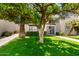 Beautiful two-story condo with manicured lawn, mature trees, and secure gated entry at 7684 E Minnezona Ave, Scottsdale, AZ 85251