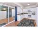 Well-lit kitchen with white cabinets, modern appliances, and access to an outdoor patio area at 7684 E Minnezona Ave, Scottsdale, AZ 85251