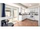 Bright kitchen with white cabinets, modern appliances, and adjacent patio access at 7684 E Minnezona Ave, Scottsdale, AZ 85251