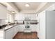 Bright kitchen features white cabinets, stainless appliances, and window with natural light at 7684 E Minnezona Ave, Scottsdale, AZ 85251
