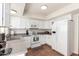 Bright kitchen with modern appliances, white cabinetry and tile flooring at 7684 E Minnezona Ave, Scottsdale, AZ 85251