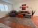 The living room offers comfortable seating, shuttered windows and terracotta flooring, with southwest decor at 7684 E Minnezona Ave, Scottsdale, AZ 85251
