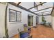 Enclosed patio with tile floors, mature landscaping, and seating at 7684 E Minnezona Ave, Scottsdale, AZ 85251