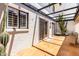 Outdoor patio area with clay tiles and a black pergola at 7684 E Minnezona Ave, Scottsdale, AZ 85251