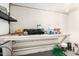 Unfinished basement space with a pegboard wall and ample storage at 7684 E Minnezona Ave, Scottsdale, AZ 85251