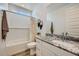Bright bathroom with a granite countertop, shower-tub combo, and modern fixtures at 8035 E Paloma Ave, Mesa, AZ 85212