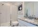 Modern bathroom features a walk-in shower with glass door, granite countertops, and white cabinets at 8035 E Paloma Ave, Mesa, AZ 85212