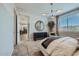Bright bedroom featuring a view into the kitchen, a large window, and modern decor at 8035 E Paloma Ave, Mesa, AZ 85212